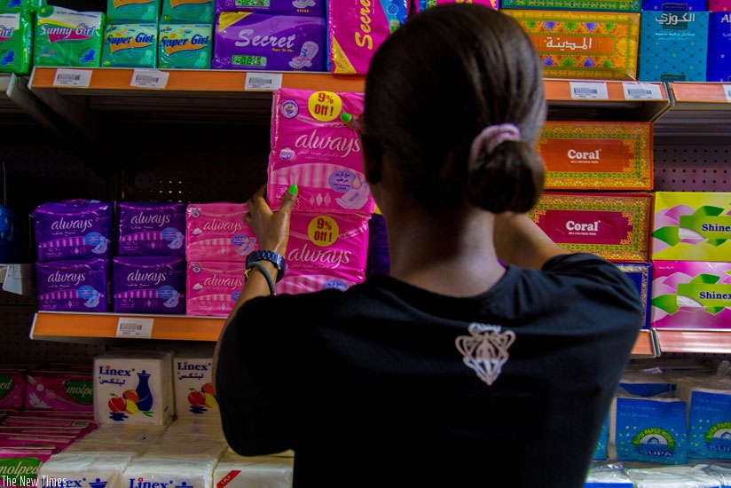 A woman buys pads in a supermarket. Although EALA passed a law waiving taxes on pads, most girls, especially in rural areas, can't afford them. (Doreen.Umutesi)