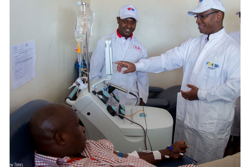 Dr Patrick  Ndimubanzi, the state minister of public and primary healthcare (C), launches the new apheresis blood donation machine to mark the Blood Donation Day as Dr Swaibu Katare, the head of National Centre for Blood Transfusion at Rwanda Biomedical Centre (L) and other officials look on yesterday.rn(All photos by Doreen Umutesi)