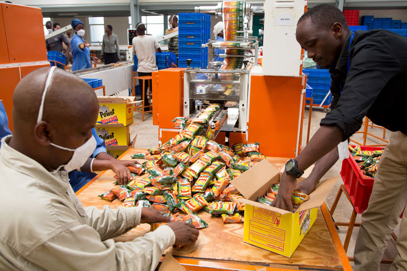 Employees of a biscuit company package the final product. (Timothy Kisambira)