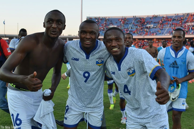 Sugira (L) celebrates with teammates, Tuyisenge (C), and Djihad Bizimana after the historic win in Maputo yesterday. (All photos by Darren McKinstry)