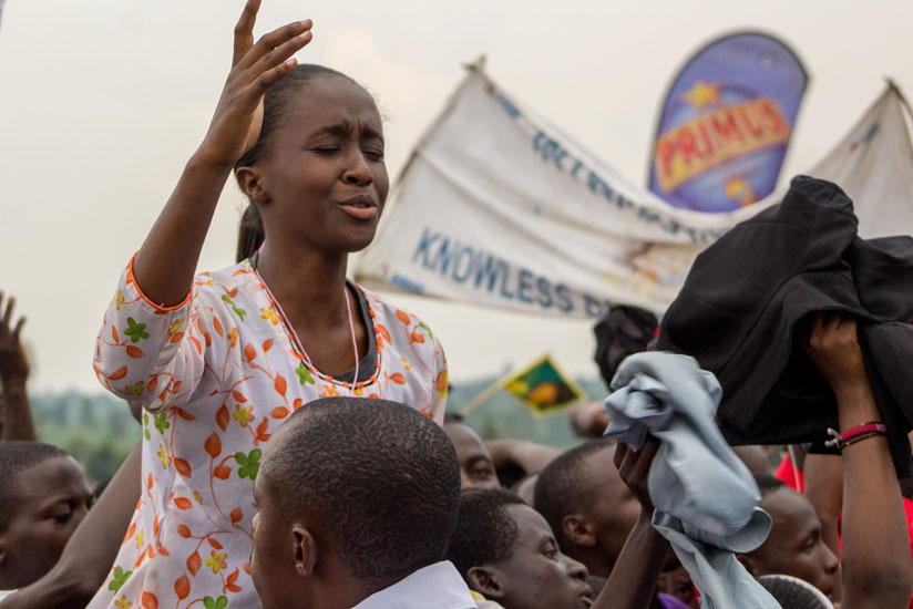 A female fan gets emotional as her favourite artiste performs. rn(All photos by Fernand Mugisha)