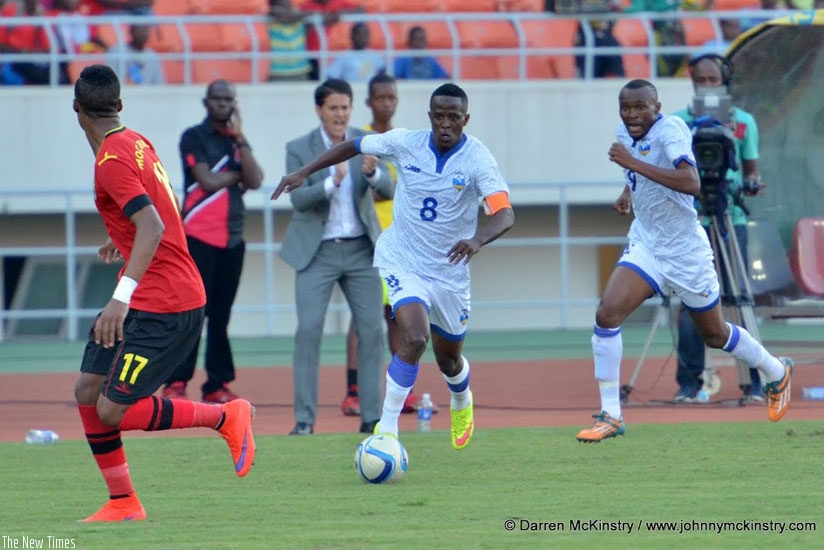 Amavubi captain Haruna Niyonzima dribbles past the Mozambique players on Sunday. (Darren McKinstry)