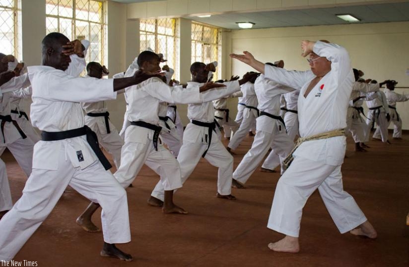 Sensei Mori Toshihiro (R) takes Rwandan Karatekas through basic Kata stances on Sunday. (Fernand Mugisha)