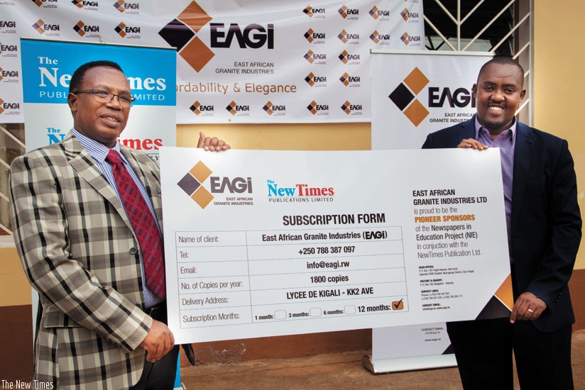 Lycee de Kigali's headmaster Martin Masabo (left) and East African Granite Industries' general manager Andrew Kulayige present the agreement to the public after the latter signed a partnership with The New Times Publications to supply the paper to the school daily. (All photos by Faustin Niyigena)