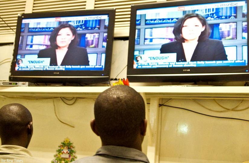 People watch television at a Star Times outlet in Kigali. (File)
