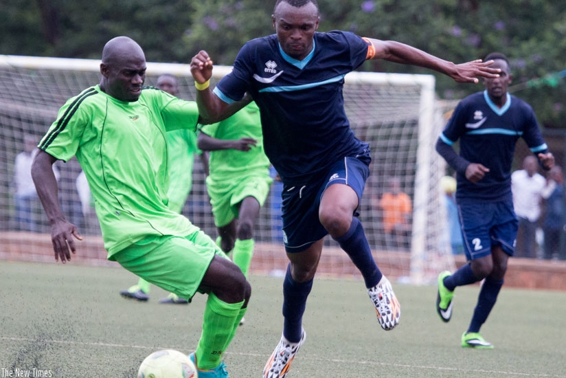 Police FC captain Jacques Tuyisenge (R) tries to escape a challenge from a Kiyovu defender during a league game this season. (Timothy Kisambira)