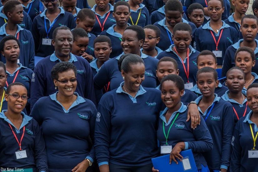 First Lady Jeannette Kagame (C) and Speaker of Parliament Donatille Mukabalisa (L) with school girls who participated in a one-day youth forum organised by Imbuto Foundation at Parliament. (Timothy Kisambira)
