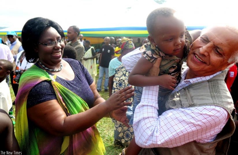 Mukantabana and Azam interact with a refugee child at Mahama camp on Saturday. (Stephen Rwembeho)