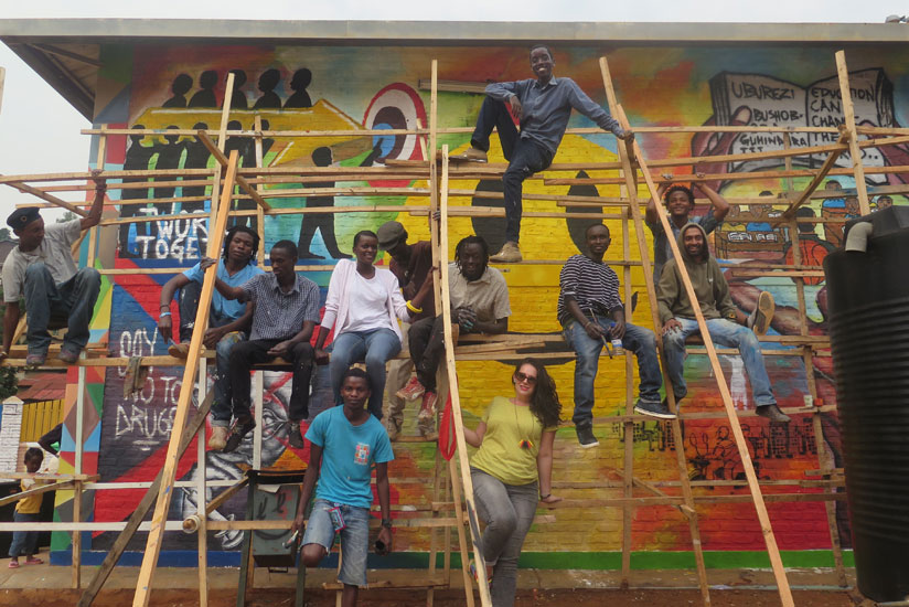Participants pose for a photo after an interactive muraling and painting session at the Kimisagara One Stop Youth Center. (All photos by Moses Opobo)