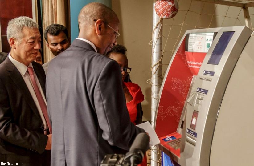 Rwangombwa launches the Union Pay card as Amb. Shen looks on. (Timothy Kisambira)