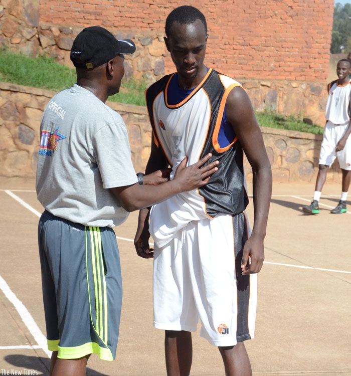 APR Captain Parfait Ishimwe (R) listens to Coach Cliff Owuor during a league game against 30 Plus in April. (Sam Ngendahimana)