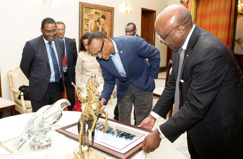 Kaberuka (R) and Kagame admire an artwork at State House during his farewell to the President on Tuesday. (Village Urugwiro)