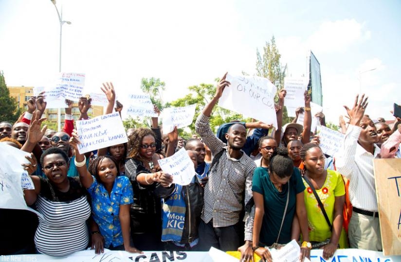 Some of the protesters who 'stormed' the British High Commission office in Kigali, yesterday, demand for the immediate and unconditional release of Lt Gen Karenzi Karake. (Doreen Umutesi)