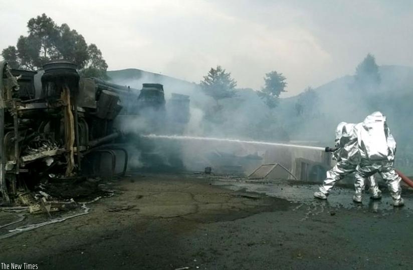 Police firefighters battle the fire that had engulfed the fuel tanker after the accident yesterday.  (Jean d'Amour Mbonyinshuti)
