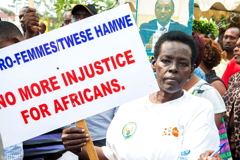 A protester at the UK High Commission in Kigali holds a placard demanding for the release of Gen Karake on Thursday. (File)