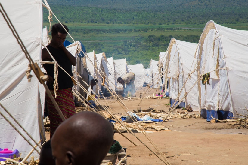 Burundian refugee prepares a meal at Mahama Camp. The number of Burundian refugees in camps in Rwanda now stands at 43,000. (Timothy Kisambira)