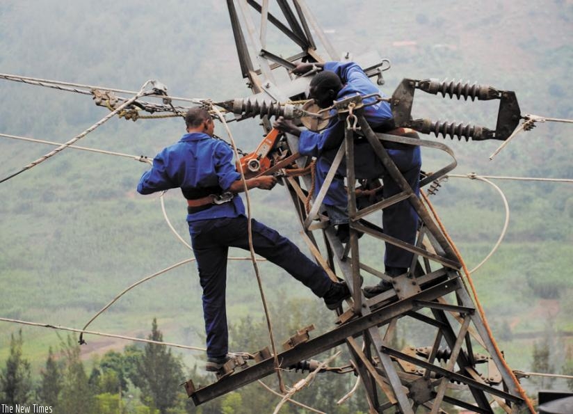 Workers repair a power line in Kigali. Power infrastructure is key to ensuring constant power supply. (File)