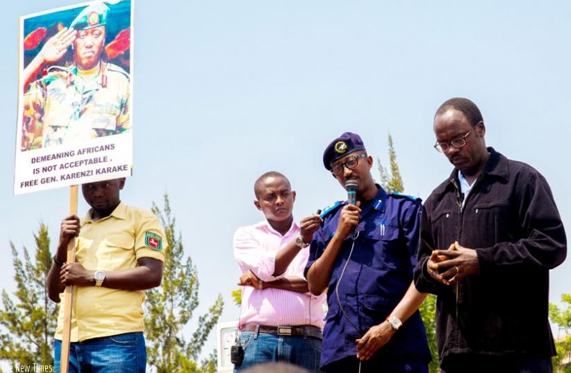 Police spokesperson Celestine Twahira urges the protesters at the UK High Commission in Kacyiru to call off the sit-in demonostration as City of Kigali mayor Fidele Ndayisaba looks on yesterday.(Doreen Umutesi)