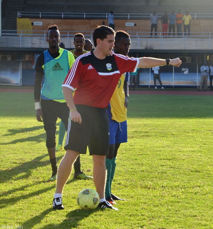 McKinstry, seen here with Amavubi players during a past training session is not bothered that  APR players will not play against Bafana Bafana. (S. Ngendahimana)