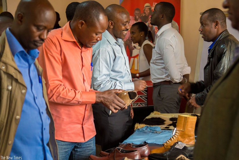 An exhibitor displays his commodities during the SMEs exhibition in Kigali recently. (D.Umutesi)
