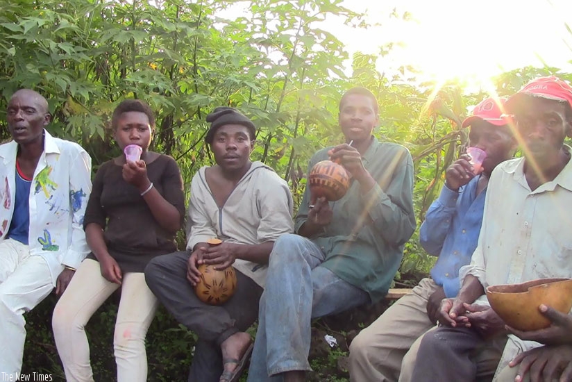 A group of people drinking Urwagwa in Rubavu. (Solomon Asaba)