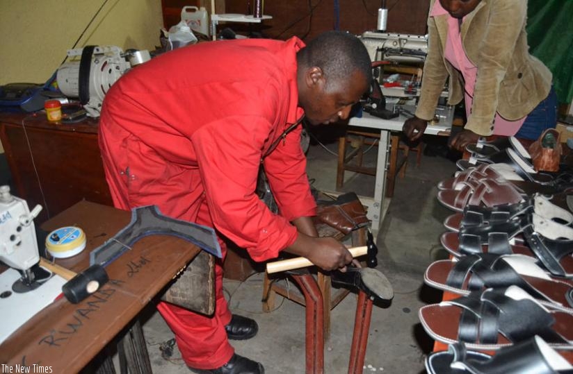 Micheal Habumugisha makes leather products in his workshop in Musanze. Such entrepreneurs need better machinery to enable them produce better products for a larger market instead of importing the same products from countries that get leather from Rwanda in raw form. (J. MBonyinshuti) 