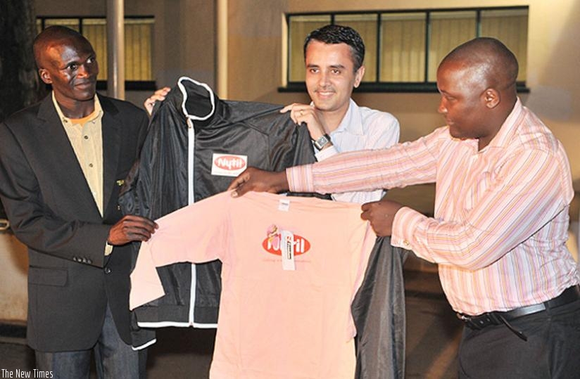 Stephen Kiprotich (left) the reigning World and Olympic marathon champion with Nytil officials. The textile firmu2019s product has been ignored in favour of cheap Chinese and Indian imports. (Net photo) 