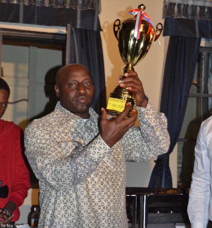 Inspector General of Police Emmanuel K. Gasana shows off Police H-ball club's Heroes Day trophy. (Courtesy)