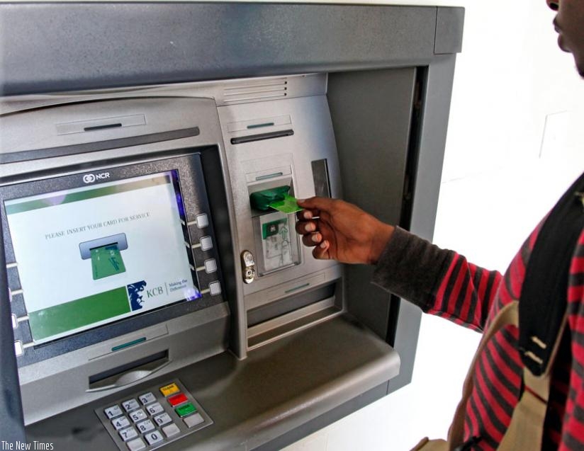 A KCB client uses an ATM in Kigali. (File)