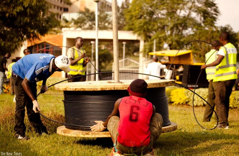 Telecom workers install fibre optic cables in Kigali last year. (File)