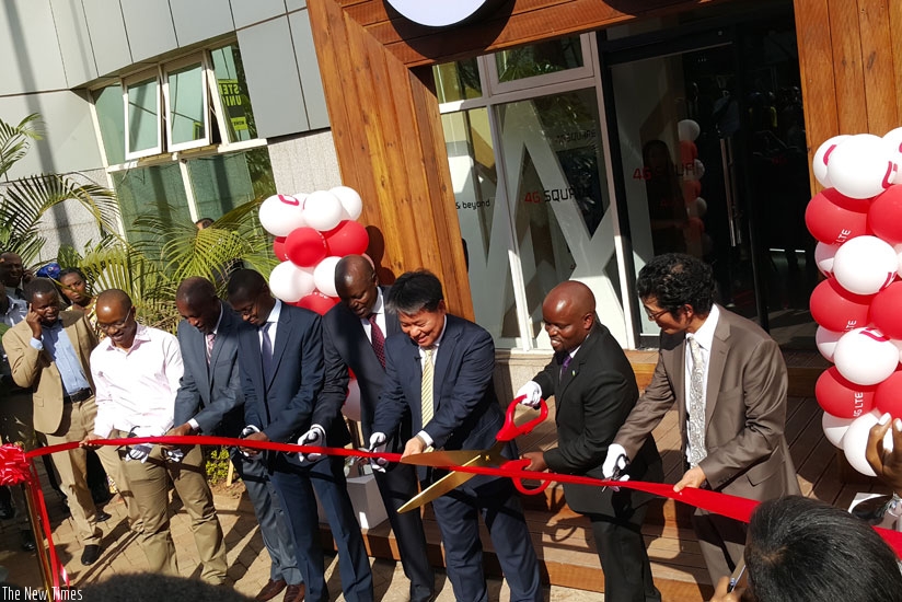 With giant scissors, the minister of youth and ICT, Jean-Philbert Nsengimana (2nd from right) cuts the ribbon unveiling the 4G Square in Kigali flanked by the chief executive officer of Olleh Rwanda Networks to his left and other officials. (Courtesy)