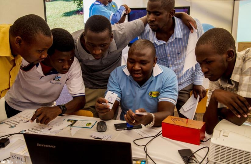 Students of the University of Rwanda's College of Science and Technology view a system of tracking day scholers during the Kigali Innovation fair for education yesterday. (Doreen Umutesi)