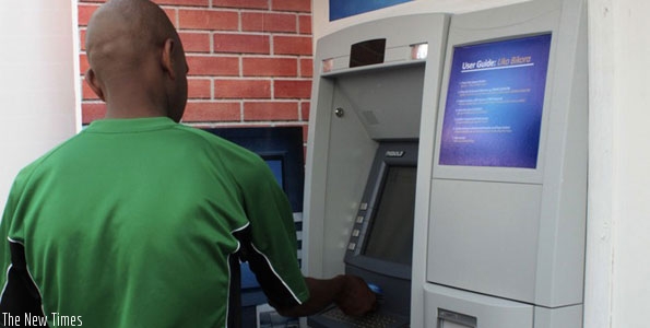 A person uses the ATM. (File)