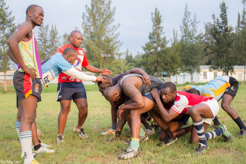 Coach Jean Baptiste Itanzi (standing left) tips the forwards on a scrum down during a training session at Utexrwa grounds. (S. Kalimba)
