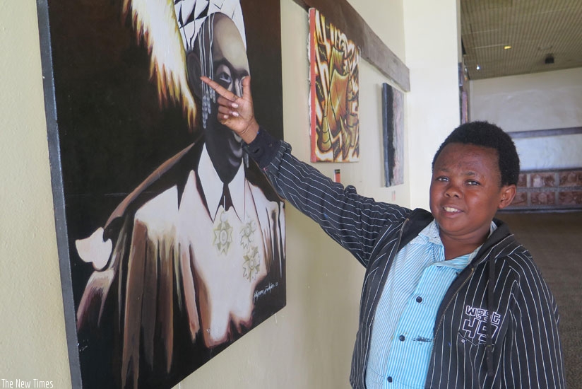 Akimana shows off a painting of King Rudahigwa. (Moses Opobo)