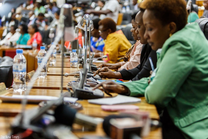 Members of Parliament vote in support of citizens' call to amend Article 101 of the Constitution to allow President Paul Kagame run for a third term in office come 2017, yesterday, at Parliament. (All photos by Timothy Kisambira)