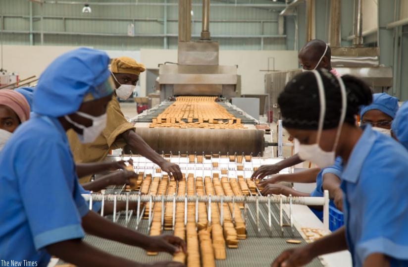 Workers at ADMA Biscuit factory in Kigali sort biscuits. (Timothy Kisambira)