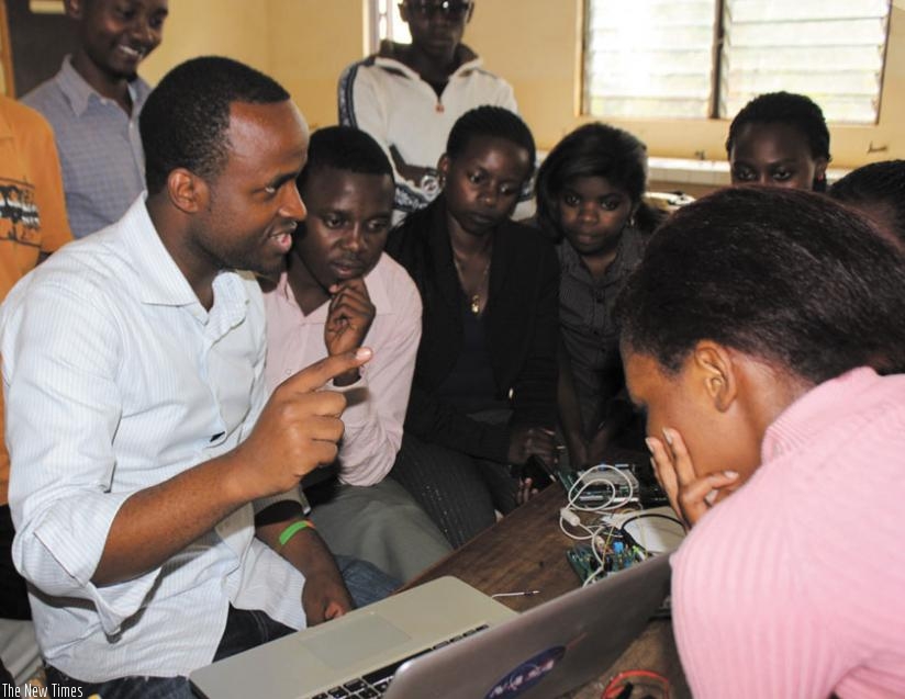 Creation Hill's proprietor Twagirayezu (left) briefs IT enthusiasts at one of the technology fairs he conducted last year. The founder is a previous winner of the Digital Change-makers competition. / Courtesy.