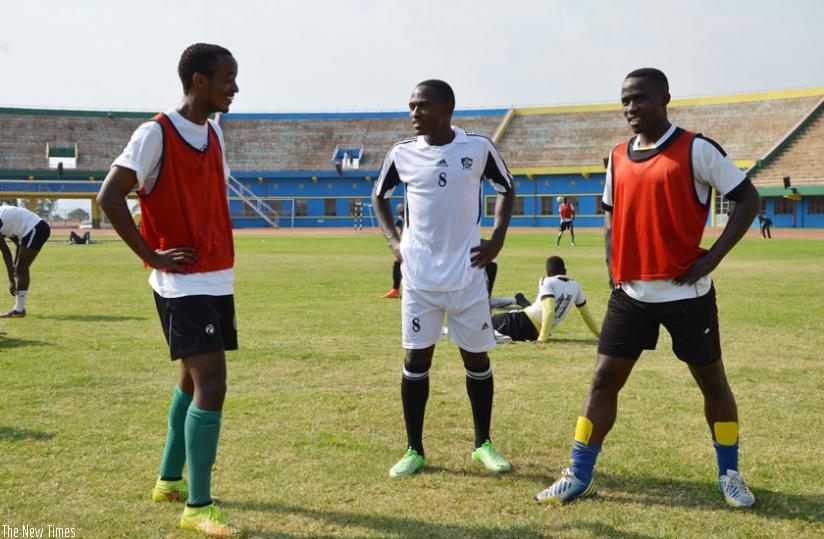 New signing Djihad Bizimana (C) stretches alongside his new teammates Yannick Mukunzi (L) and Michel Ndahinduka on Monday afternoon at Amahoro Stadium. (Sam Ngendahimana)