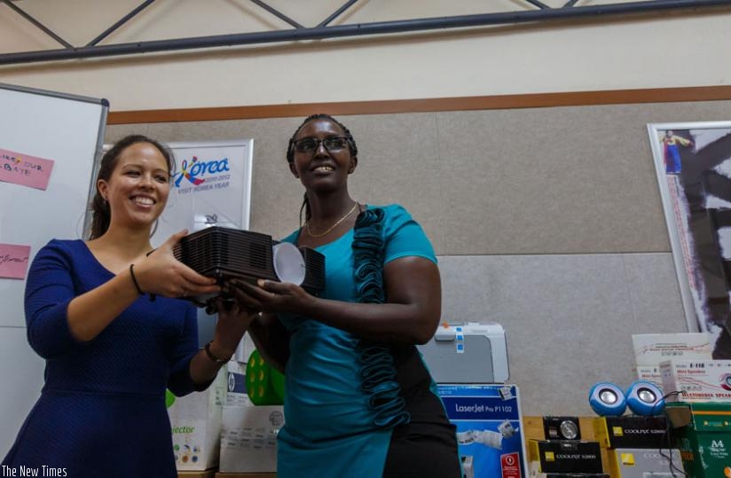 Eva Juenemann ( L),  the labour market intervention advisor  at GIZ,  hands  over  a projector  to Agnes Mukamuligo,  the vice principal in charge of administration and finance at IPRC Kigali. (Timothy Kisambira)