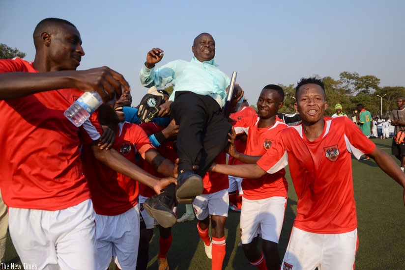 Bugesera  coach Noah Nsanziyinka is carried shoulder high by his players after guiding the club to the second divison league title on Saturday. (S. Ngendahimana)