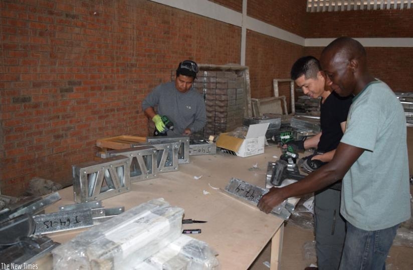 JS workers assembling components of a house at their KSEZ-based factory. (Stephen Kalimba)