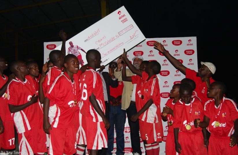 Inyange Academy  players celebrate after winning the 2015 Airtel Rising Stars season III national football title in the boys category on Sunday. (Courtesy)