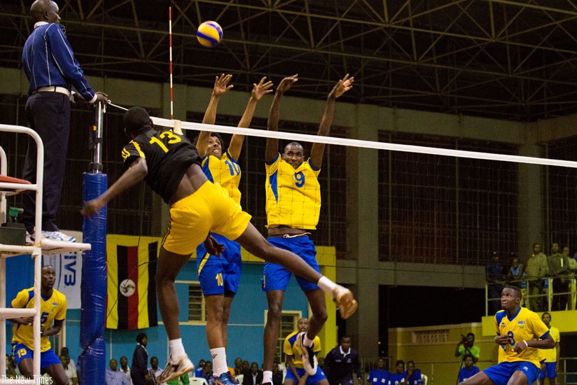 Rwandau2019s Ivan Mahoro and Vincent Dusabimana block a Ugandan opponent during the Zone V tournament in May at Petit Stade. (Timothy Kisambira)