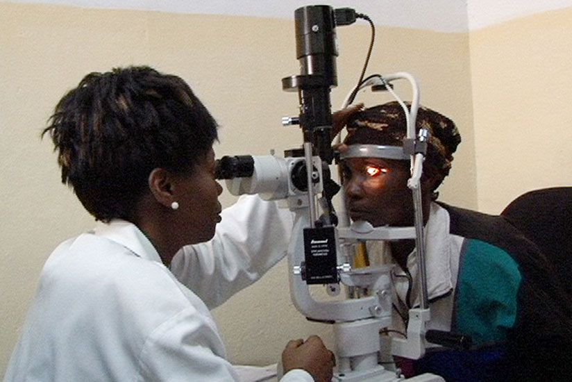 An ophthalmologist examines a patient at Ruhengeri Hospital using a modern ophthalmic laser machine. (Jean d'Amour Mbonyinshuti)