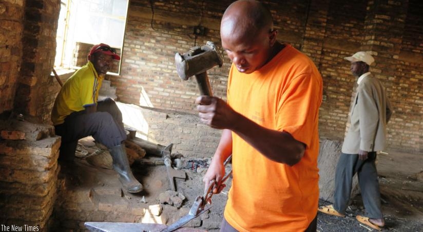 Havugimana fabricates a kitchen knife. (Emmanuel Ntirenganya)