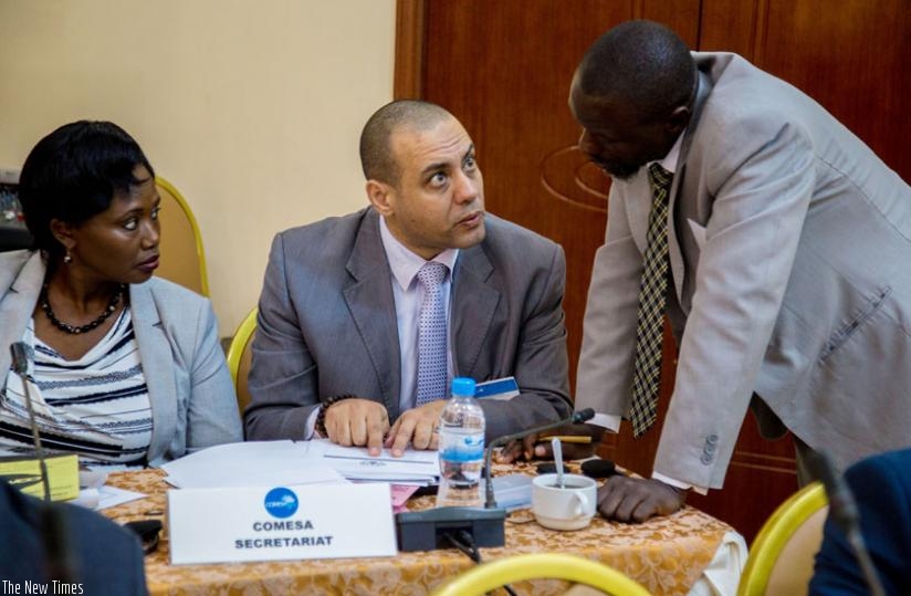 Dr Khaled Melad Rezek (C), COMESAs private sector specialist, speaks to Tasara Muzorori (R), COMESAu2019s senior trade officer, at the meeting in Kigali yesterday as Rwandas Odette Mukazi Mutanguha looks on. (Doreen Umutesi)