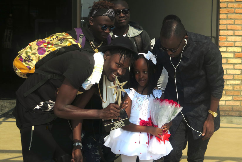 Kenzo and his crew are welcomed by a young girl at the airport. (Stephen Kalimba)