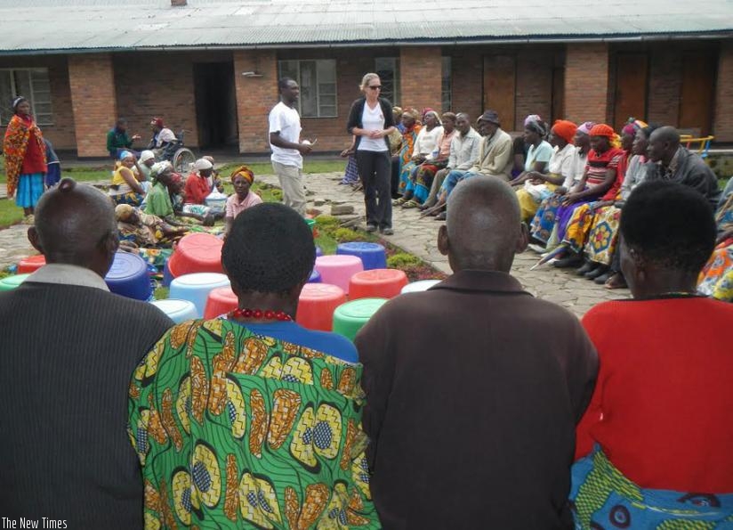 Houston (standing in the middle) speaking to some of the victims in Musanze.  (Joseph Oindo)