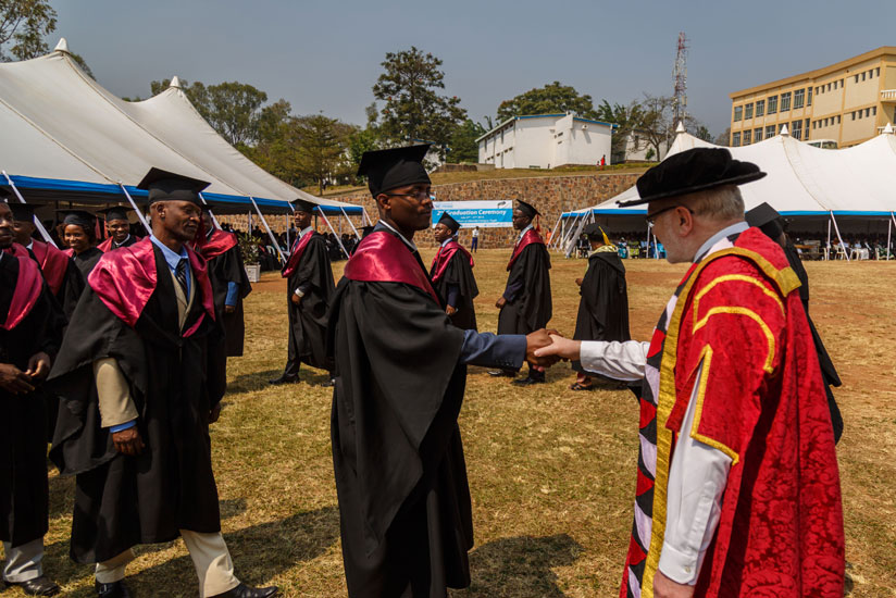 Professor James McWha, the vice Chancellor of the University of Rwanda, congratulates the graduates upon receiving their degrees. (All photos by Timothy Kisambira)